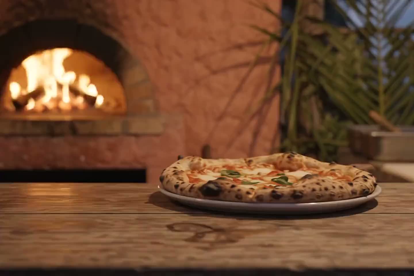 Café Project concept image showing pizza on a wooden table beside a wood-fired oven